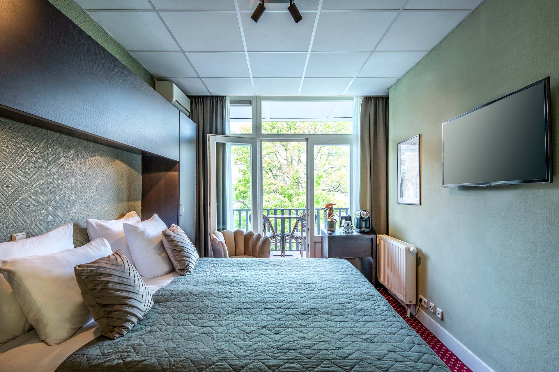The bed, television and balcony doors