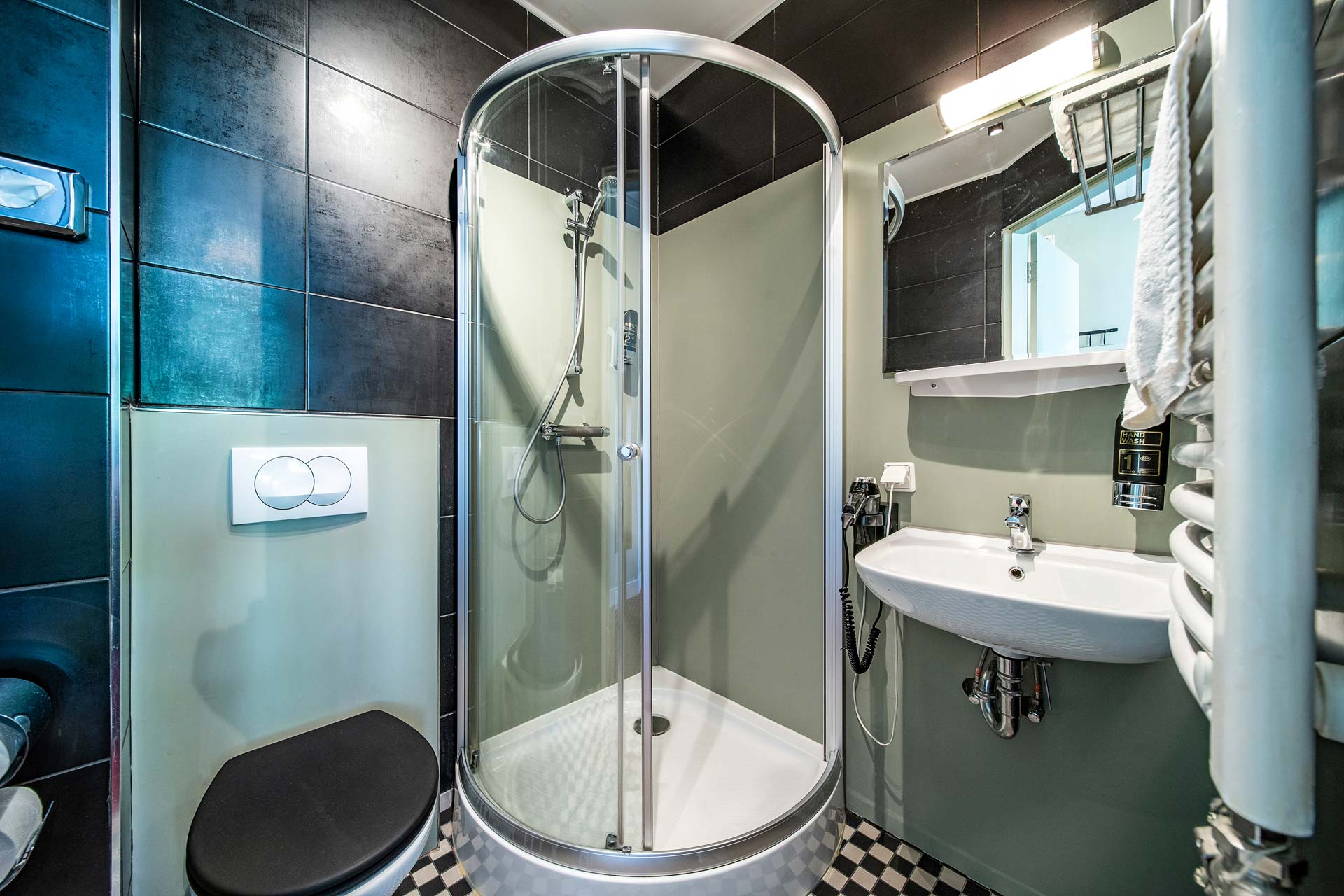 The private bathroom with a rounded shower
