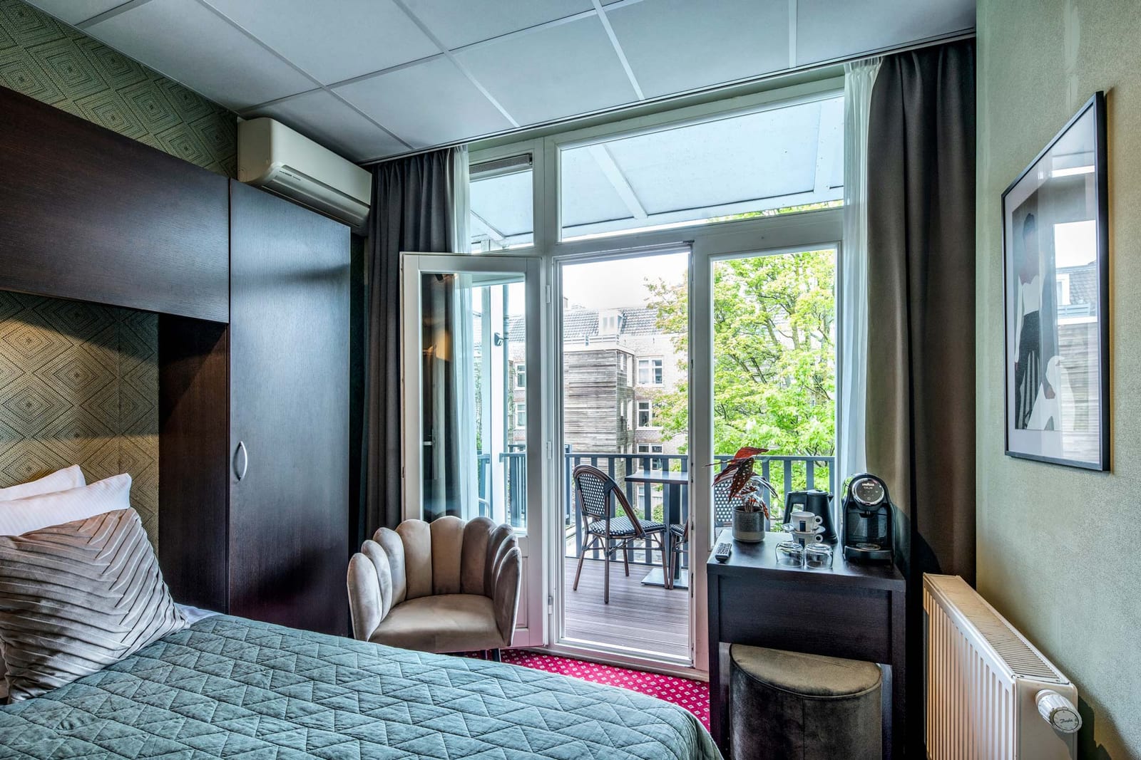 The balcony doors open onto bistro chairs, beside the coffee station