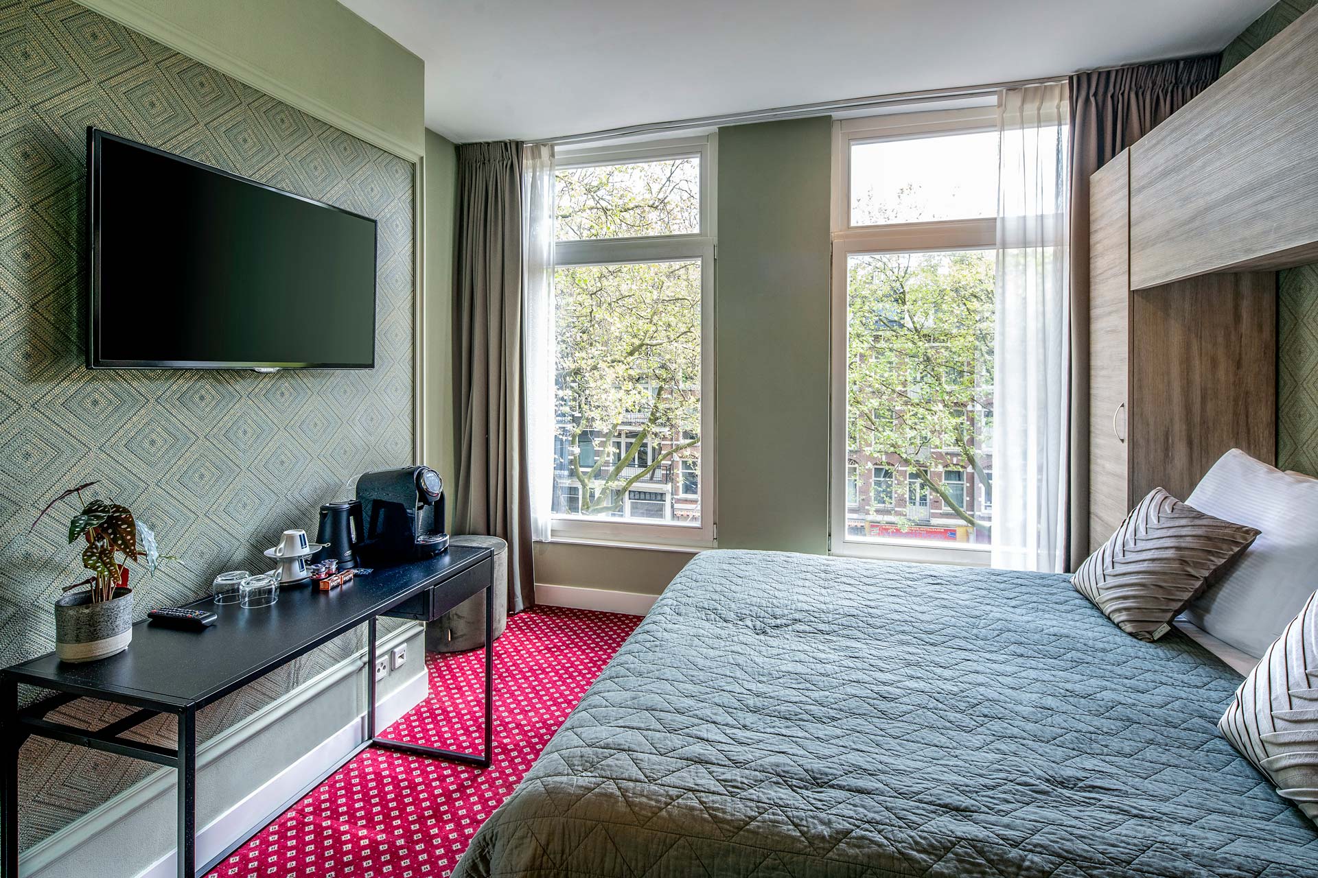 The double bed and desk with the coffee machine