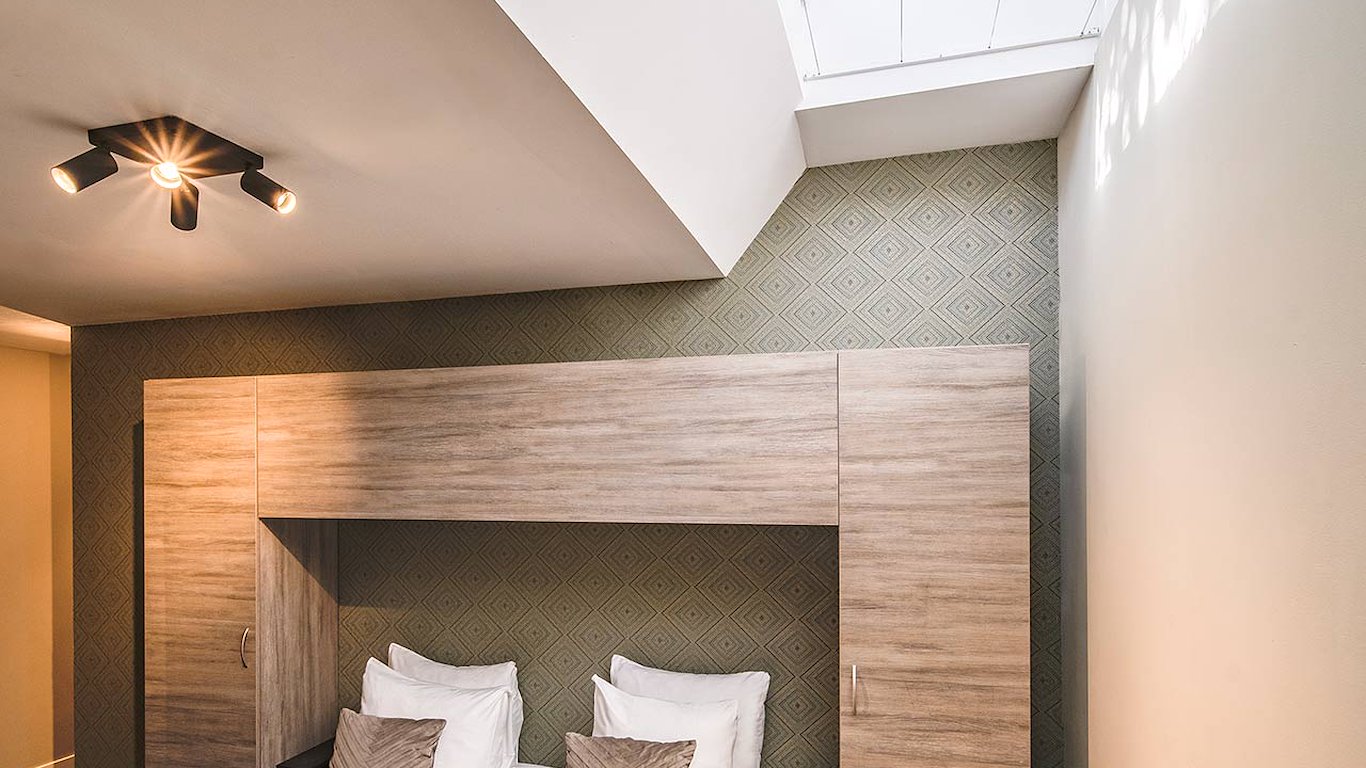 The skylight above the bed, with the timber wardrobe unit framing the headboard