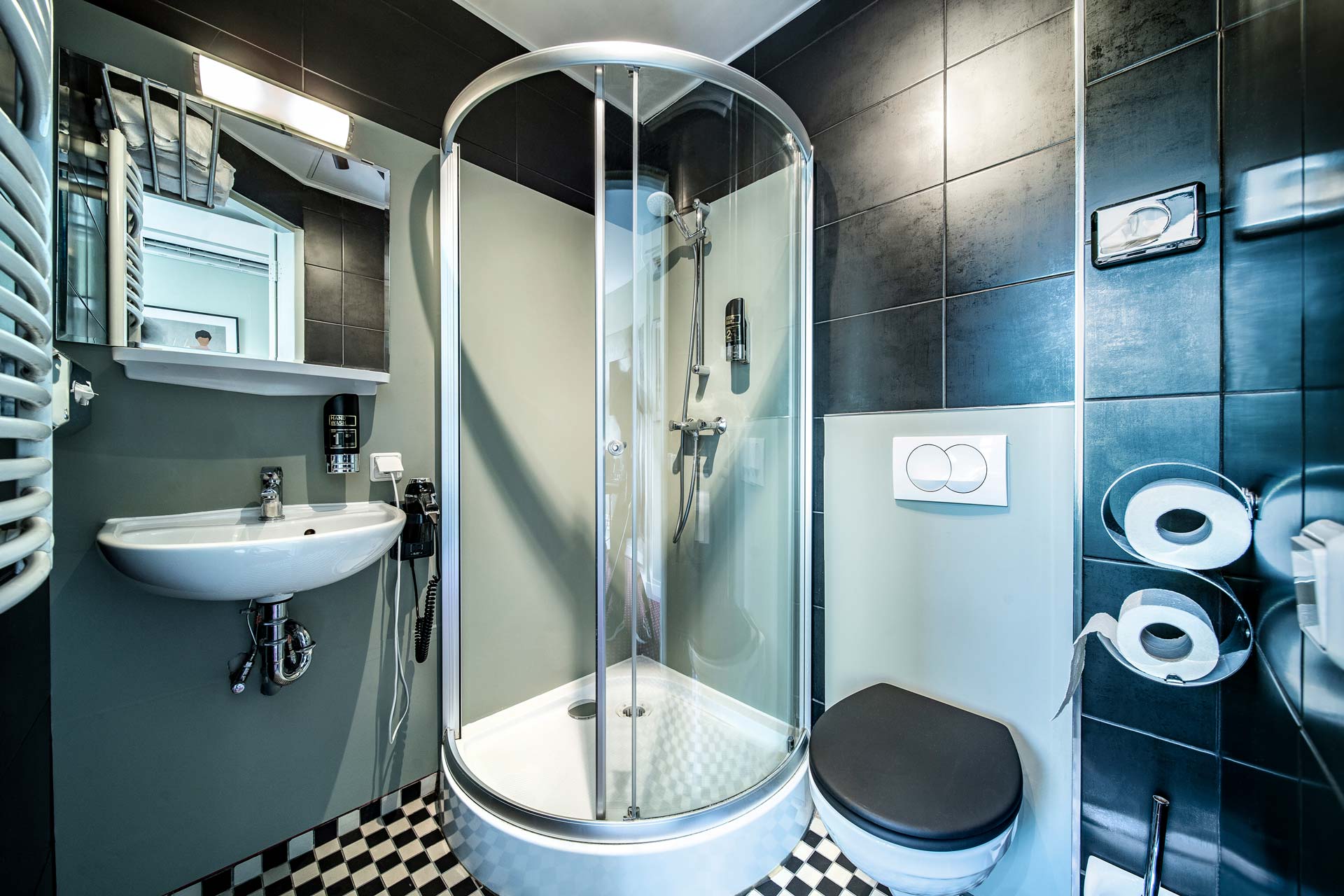 The private bathroom with a rounded shower