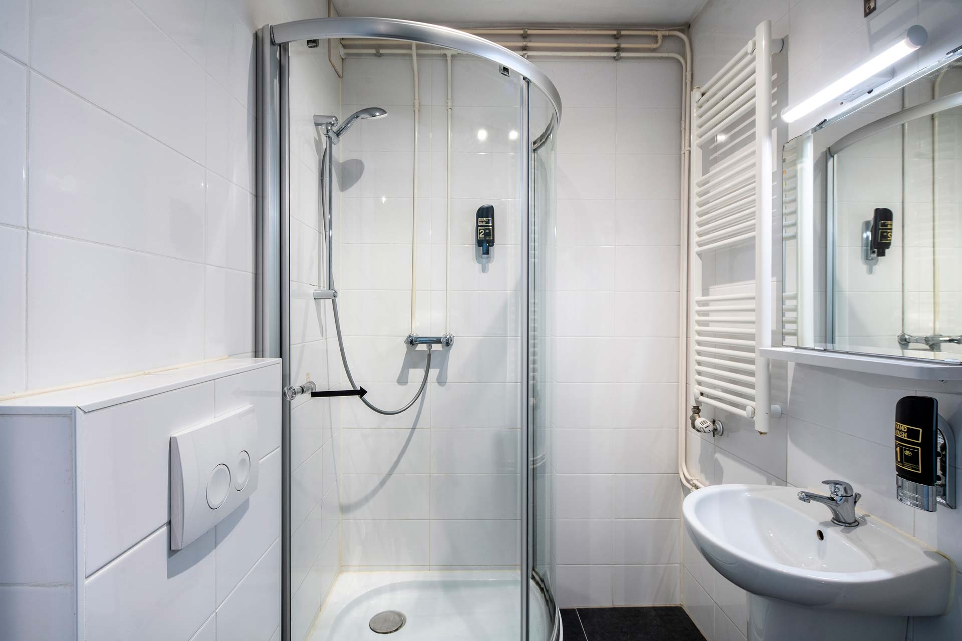 The private bathroom with a corner shower